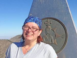 Sitting in front of the Guadalupe Peak summit monument
